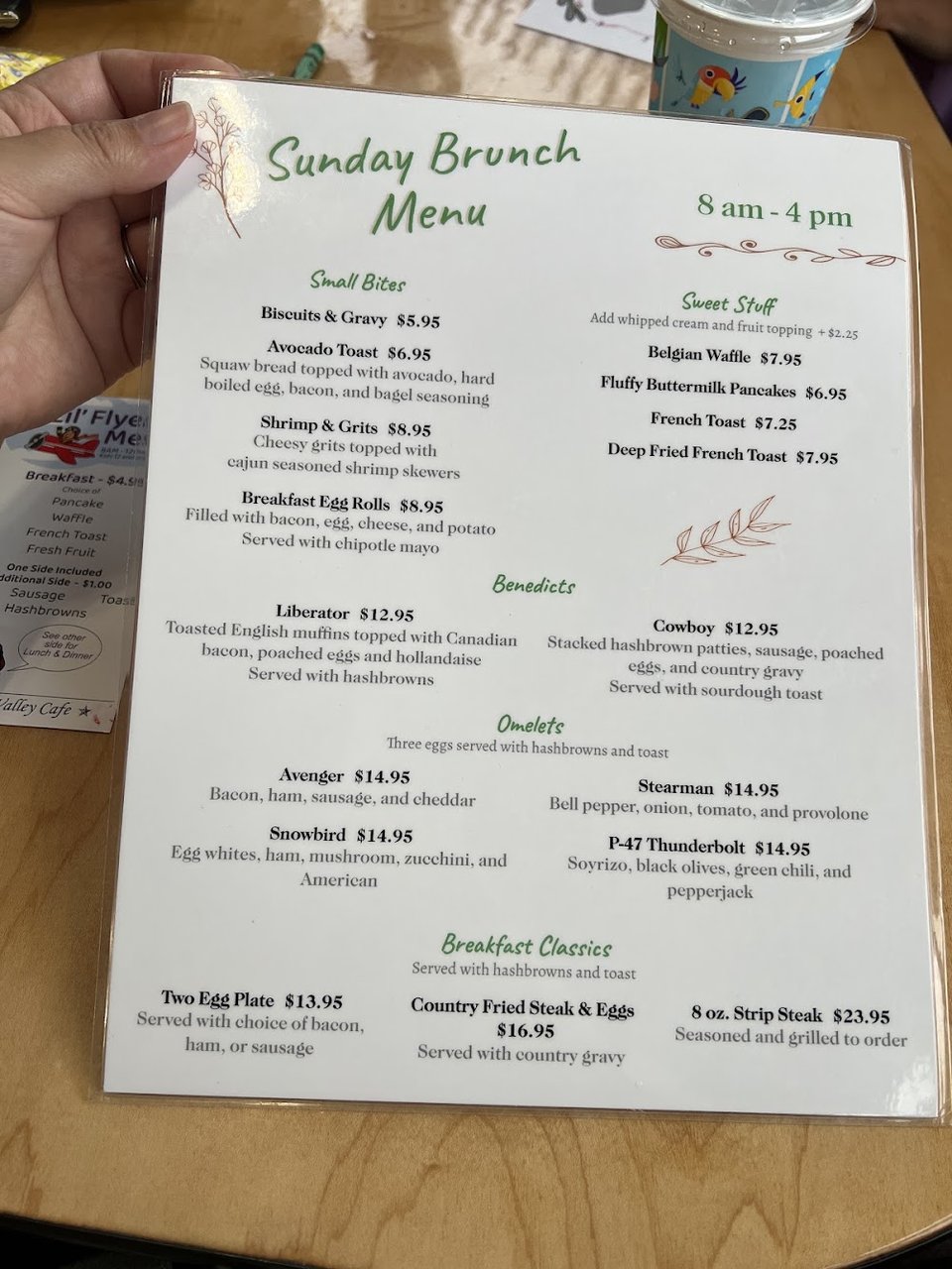 Menu board showing burritos, toast, and sides.